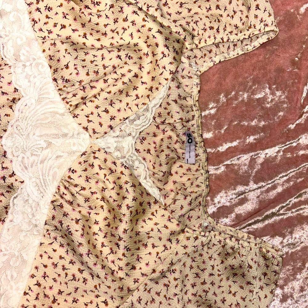 Cute, cream blouse with flowers on it.